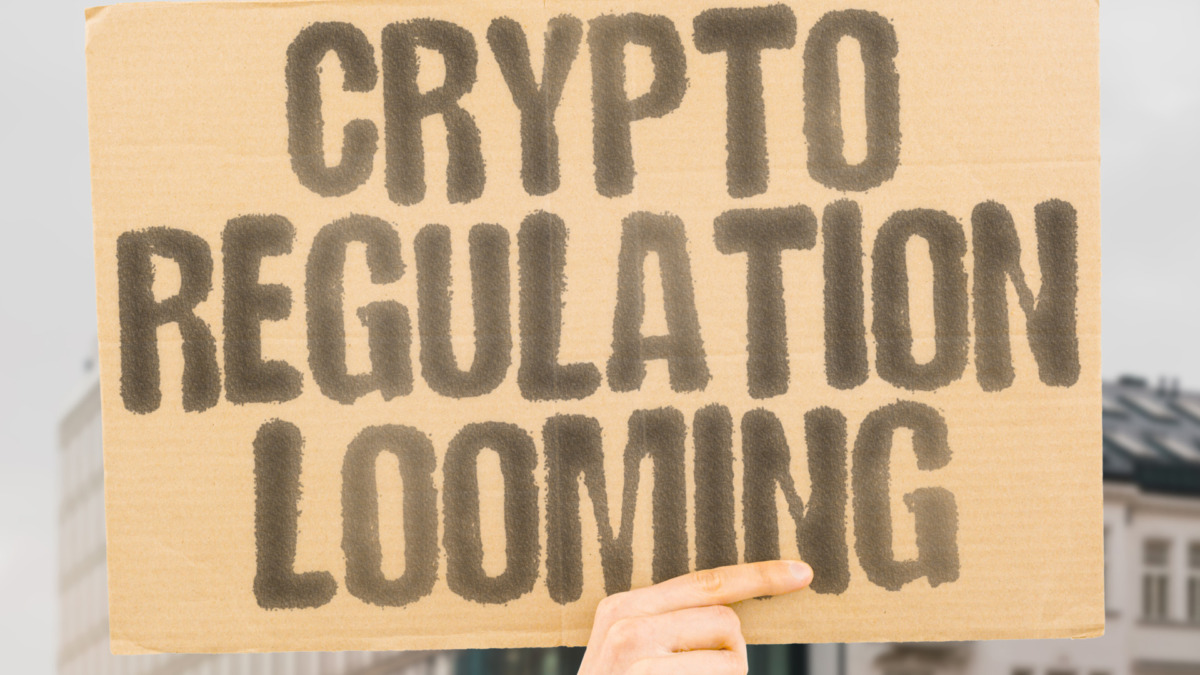 Crypto regulation looming on worn cardboard. Highlights impending rules for digital assets. OVERSIGHT. LEGISLATION. COMPLIANCE. FRAMEWORKS. GOVERNANCE. POLICIES. STANDARDS